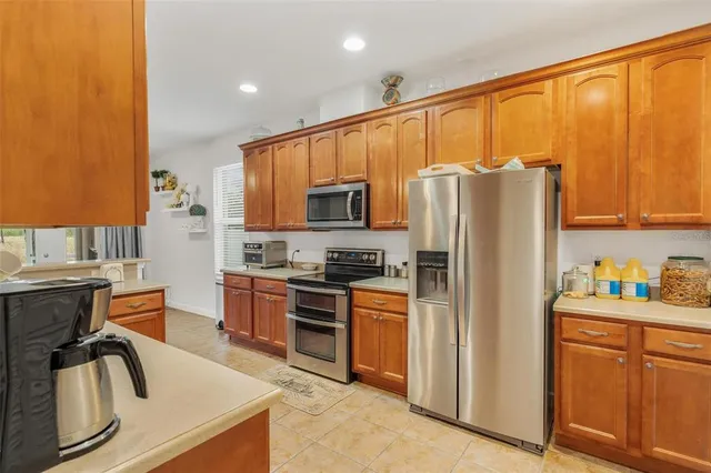 a kitchen with stainless steel appliances granite countertop a refrigerator stove and sink