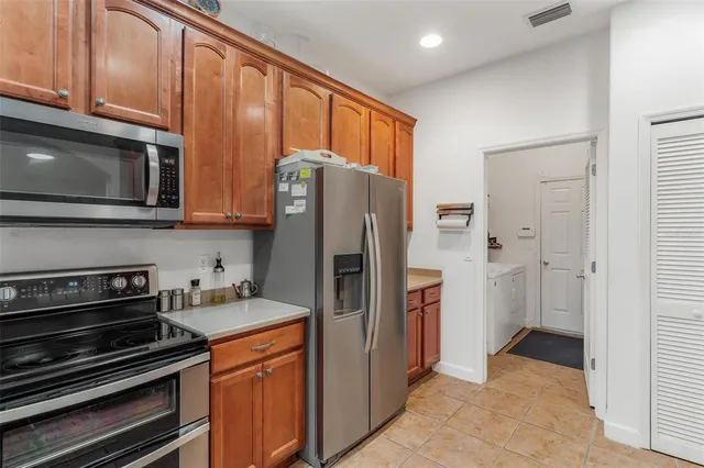 a kitchen with stainless steel appliances granite countertop a refrigerator and microwave