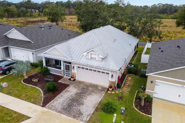 an aerial view of a house with garden space and street view