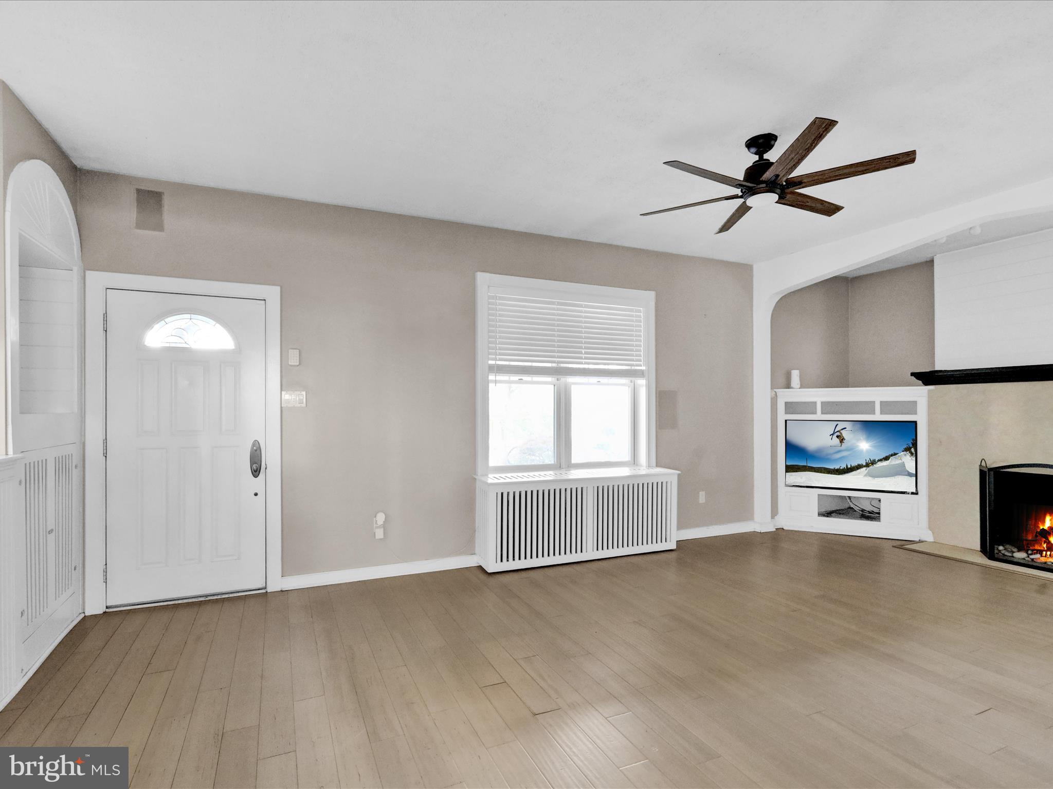 1315 Cleveland Avenue Wyomissing, PA 19610 - Photo 2 of 43 a view of an empty room with a fireplace and a window