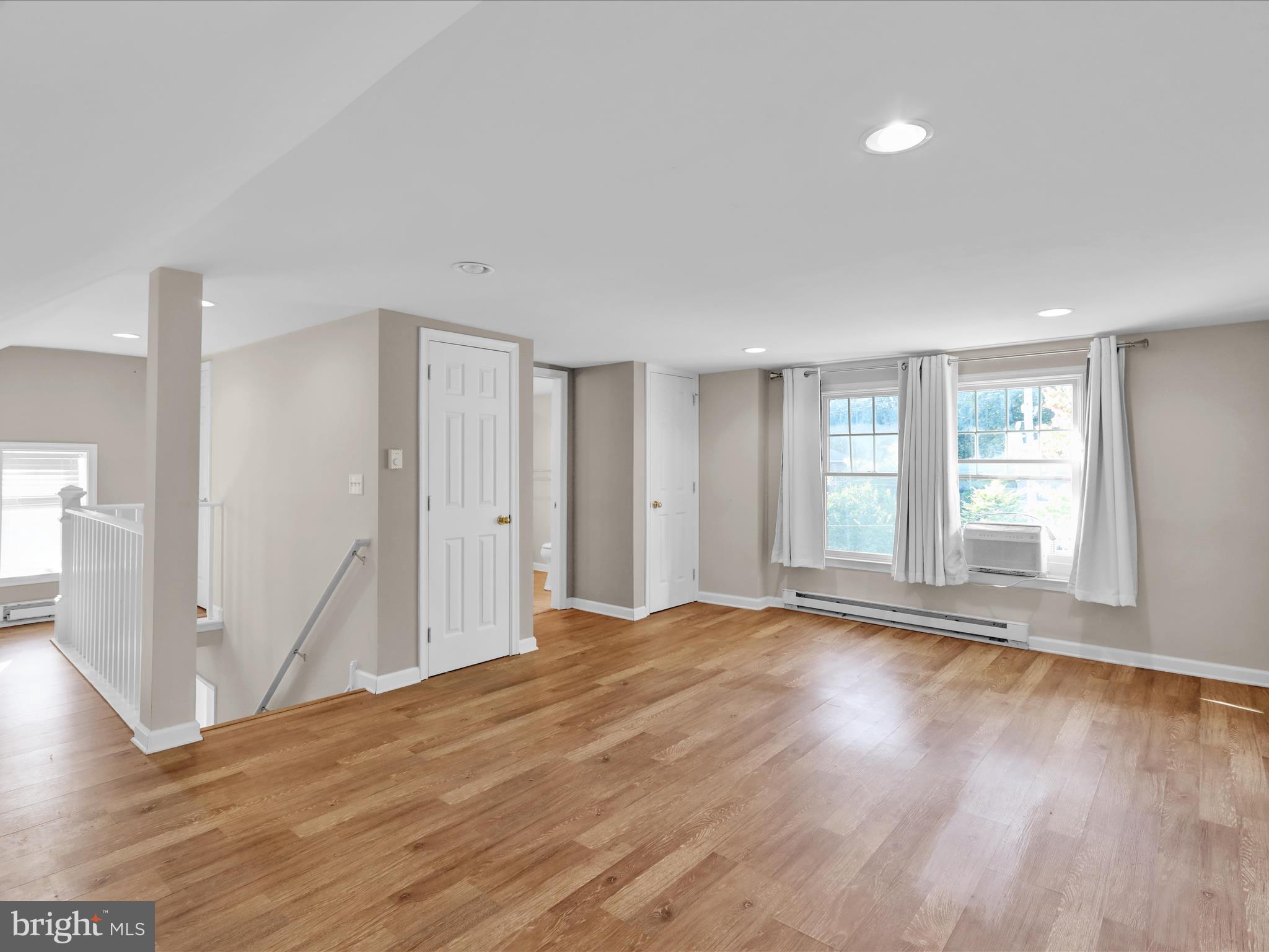 1315 Cleveland Avenue Wyomissing, PA 19610 - Photo 23 of 43 a view of an empty room with wooden floor and a window