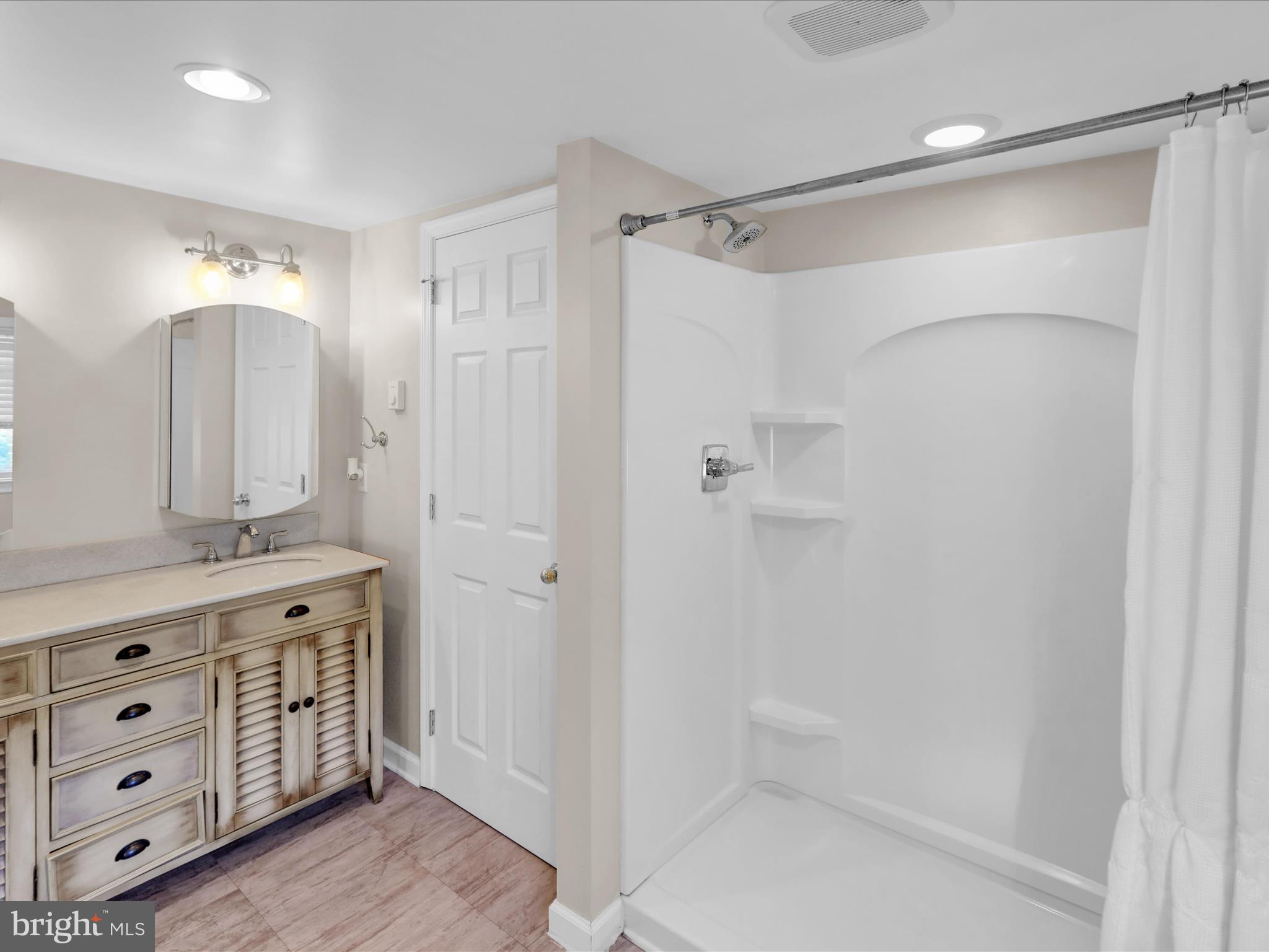 1315 Cleveland Avenue Wyomissing, PA 19610 - Photo 28 of 43 a bathroom with a shower a sink and a mirror