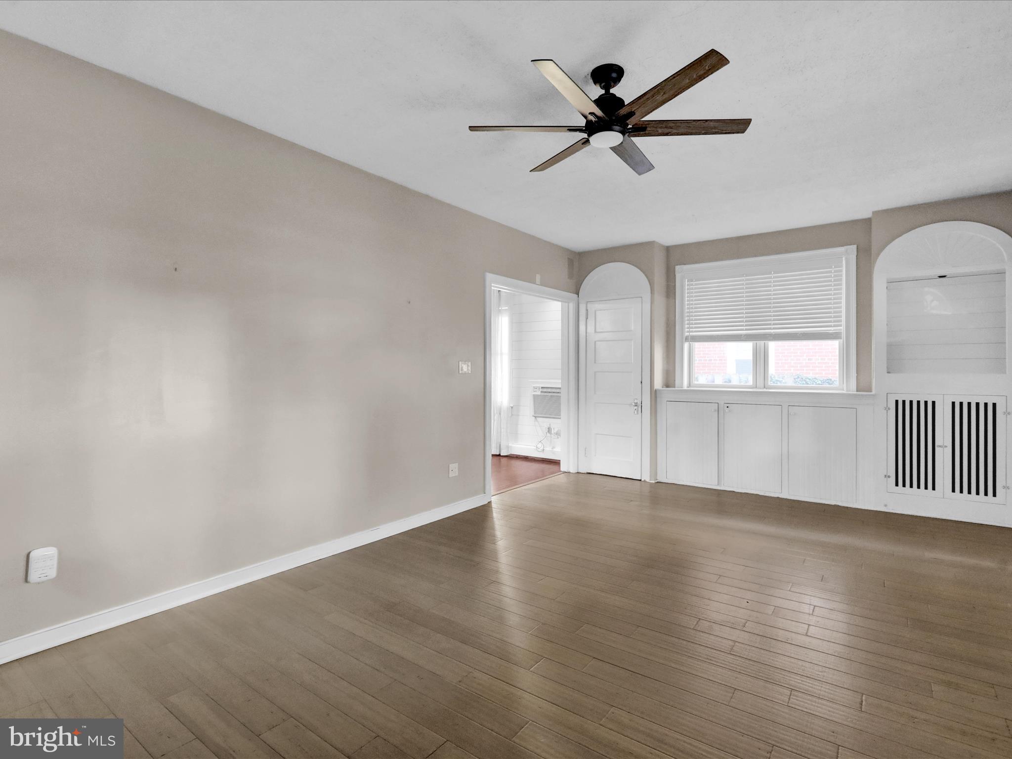 1315 Cleveland Avenue Wyomissing, PA 19610 - Photo 6 of 43 an empty room with wooden floor fan and windows