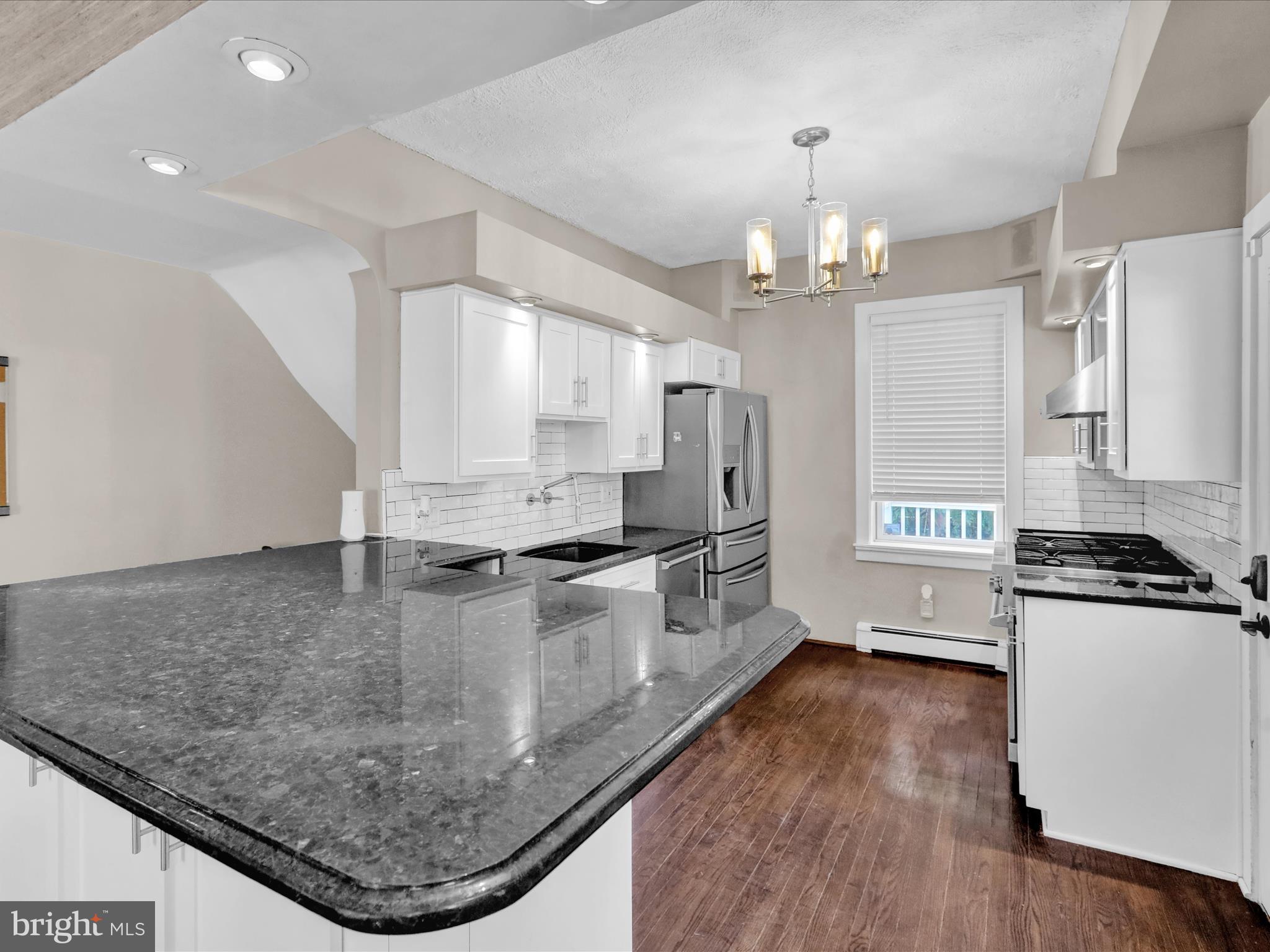 1315 Cleveland Avenue Wyomissing, PA 19610 - Photo 10 of 43 a kitchen with stainless steel appliances granite countertop a sink a stove and a refrigerator