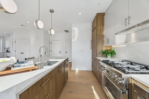 a kitchen with a sink stove and cabinets