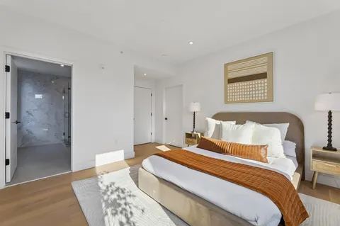 a bedroom with bed and a night stand