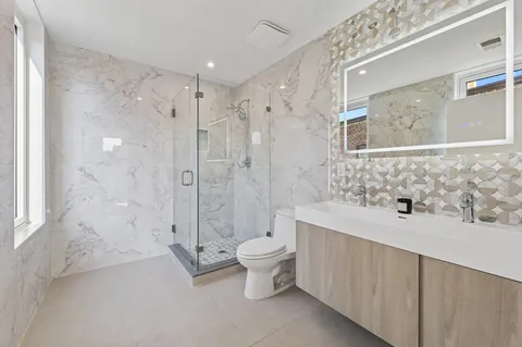 a bathroom with a sink toilet and shower