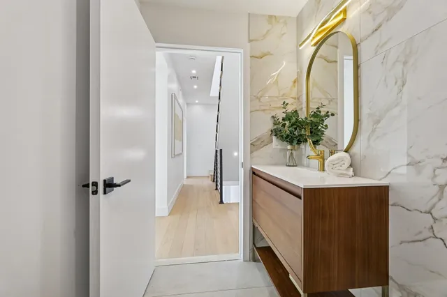 a bathroom with a sink vanity and a mirror