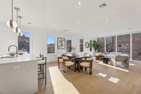 a living room with lots of furniture and a large window