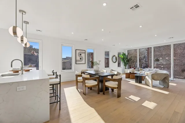 a living room with lots of furniture and a large window