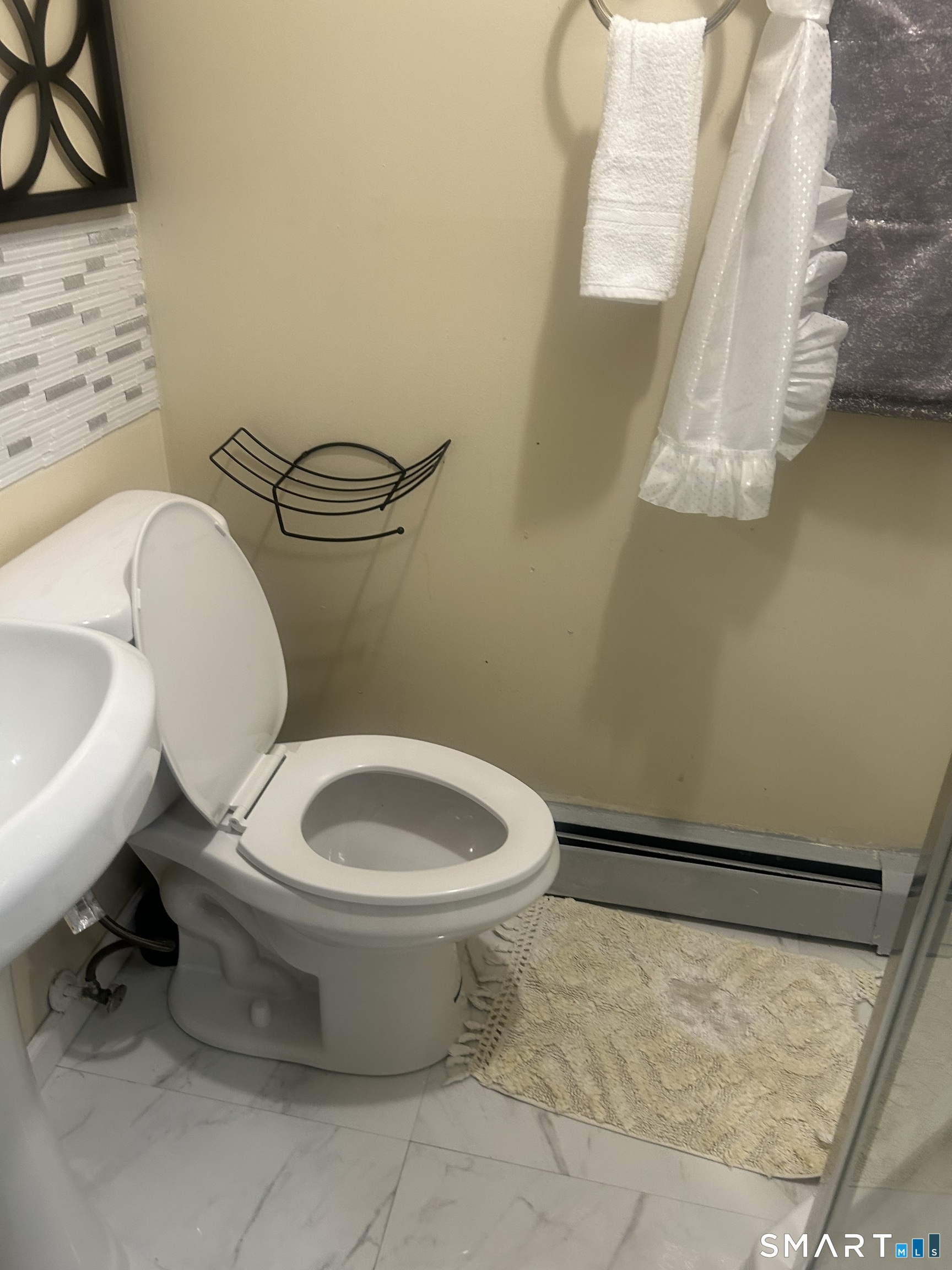 135 Pheasant Road West Haven, CT 06516 - Photo 15 of 23 a white toilet sitting next to a bathroom sink
