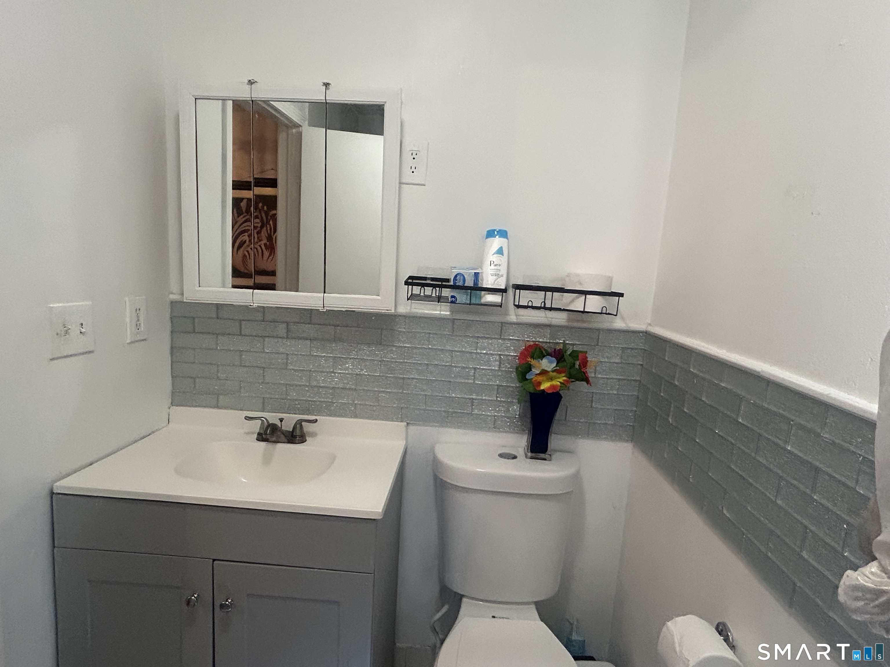 135 Pheasant Road West Haven, CT 06516 - Photo 18 of 23 a bathroom with a sink a toilet and mirror