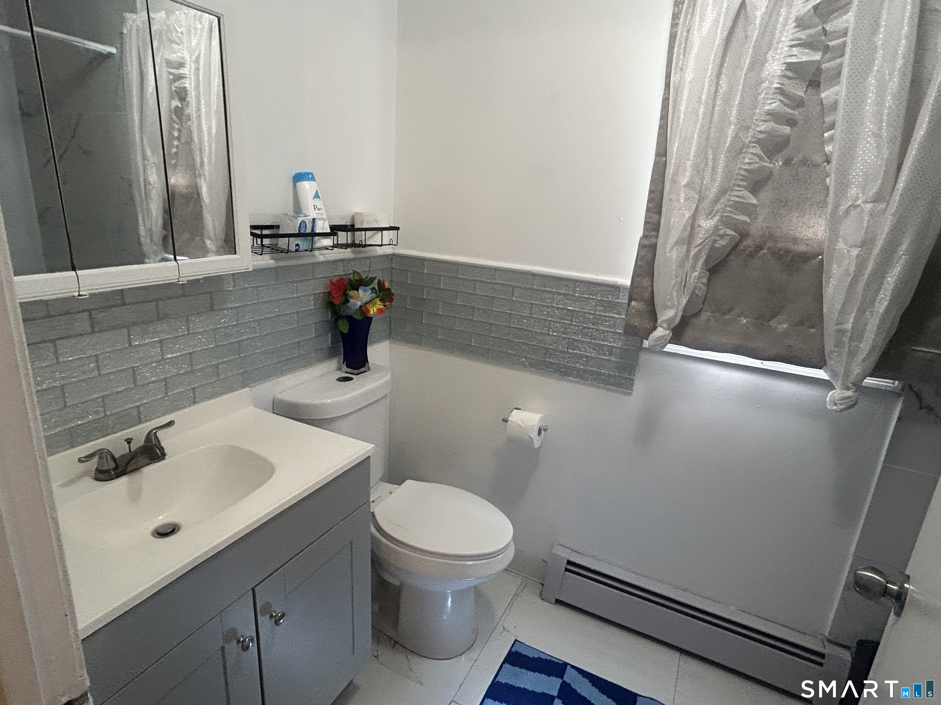 135 Pheasant Road West Haven, CT 06516 - Photo 19 of 23 a bathroom with a sink and a mirror
