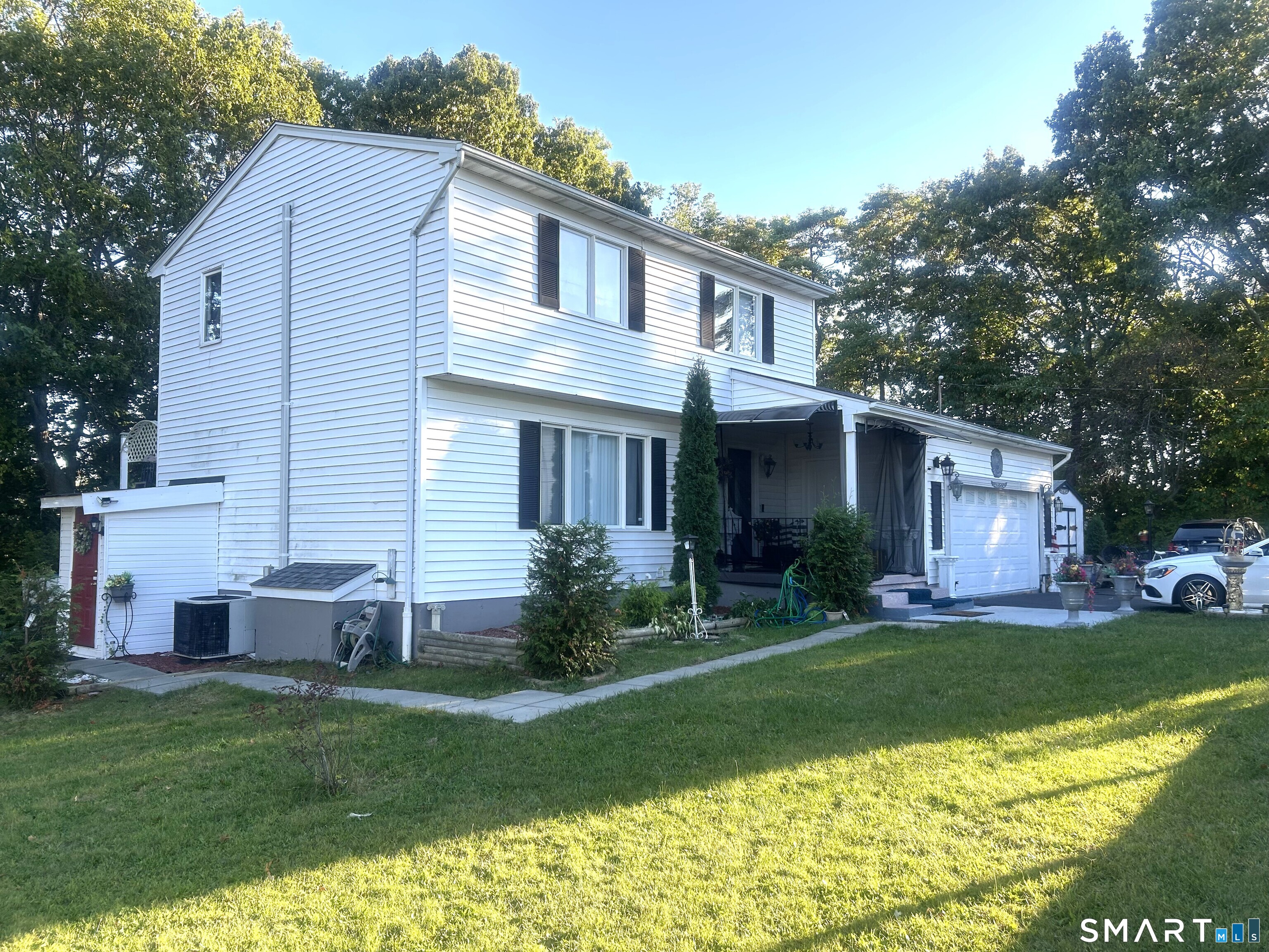 135 Pheasant Road West Haven, CT 06516 - Photo 4 of 23 a front view of a house with a yard and garage
