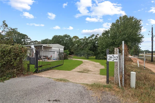 a front view of a house with a big yard
