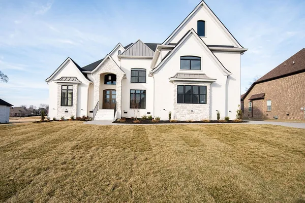 a view of house and yard with ocean