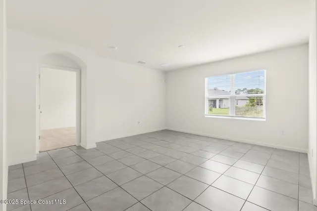 an empty room with windows and closet