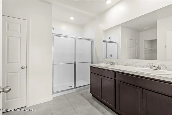 a bathroom with a double vanity sink and mirror