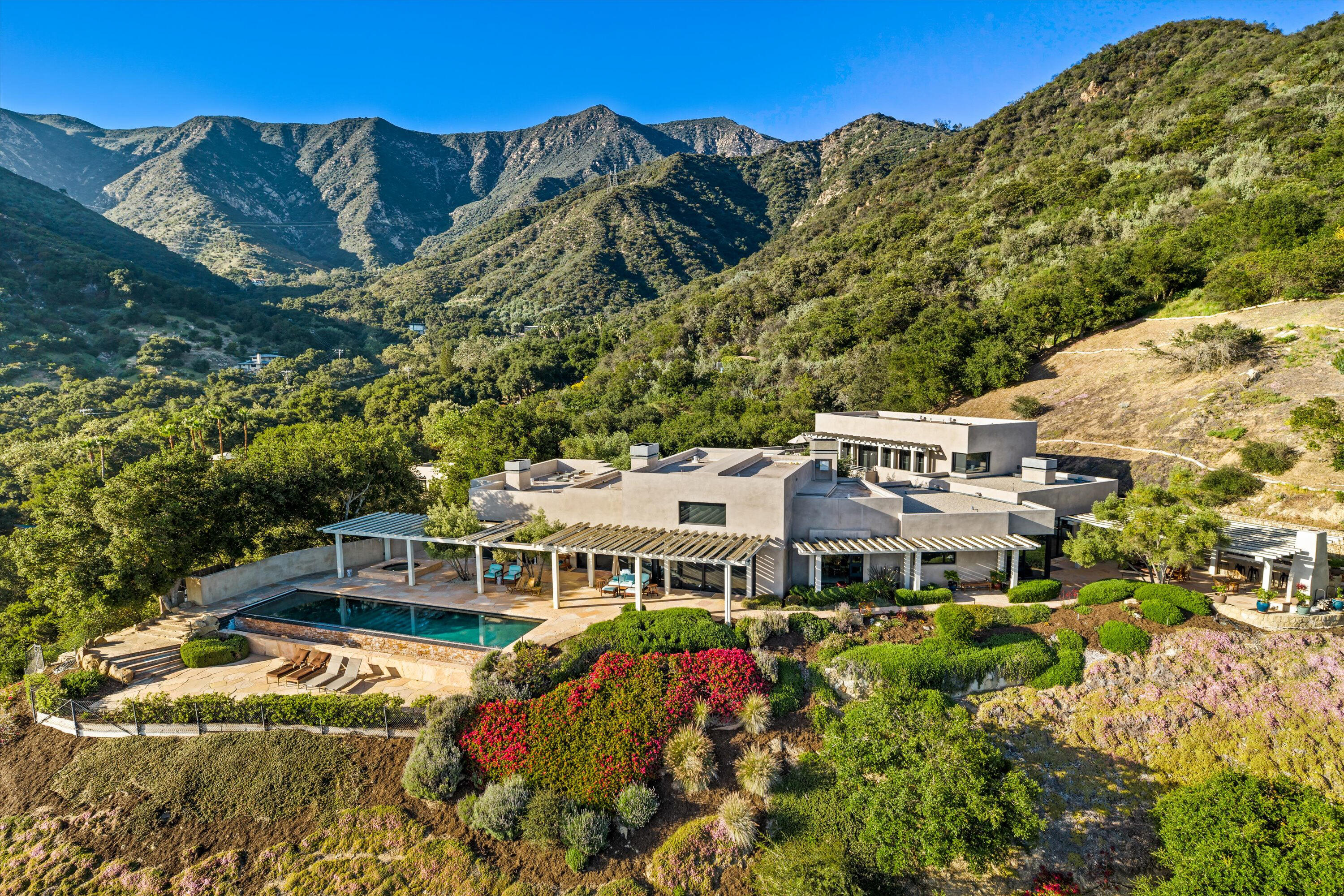 a aerial view of a house with a big yard and large trees