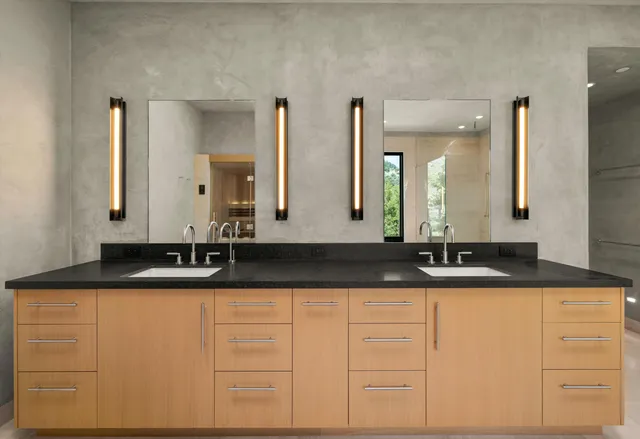a bathroom with sinks granite and a mirror