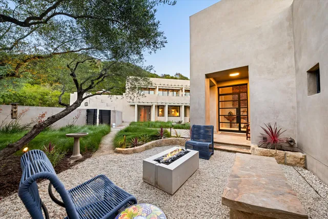 a front view of a house with garden and patio