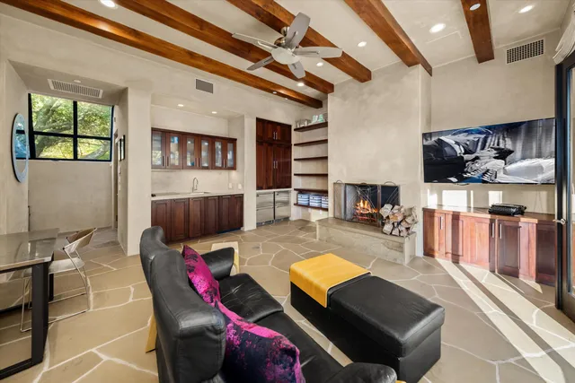 a living room with fireplace furniture and a flat screen tv