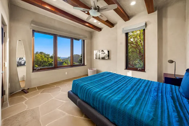 a bedroom with a large bed and a large window