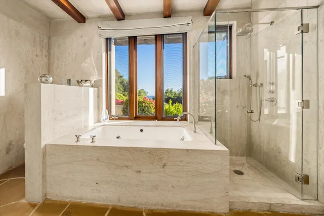 a bathroom with a bathtub and shower