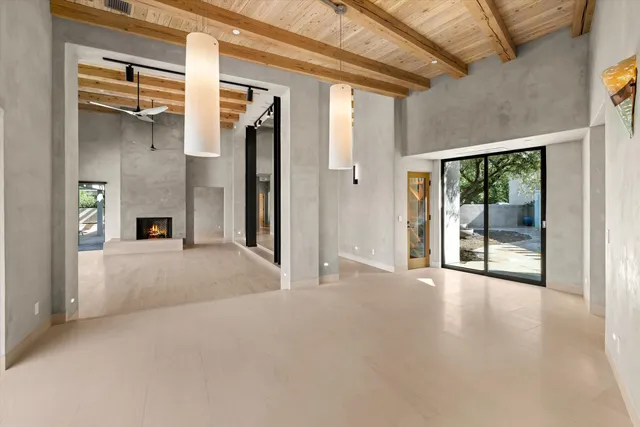 a view of a big room with a fireplace and windows