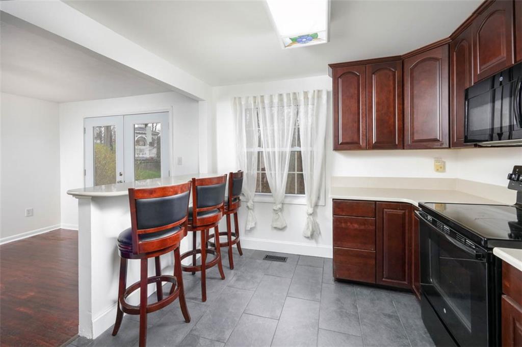 577 Surfside Drive Pittsburgh, PA 15239 - Photo 8 of 30 With bar seating in the kitchen