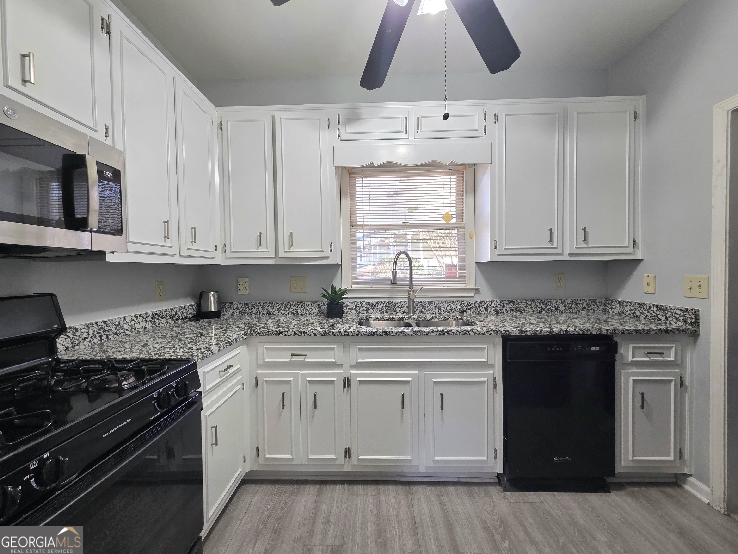 1426 Cambridge Common Decatur, GA 30033 - Photo 19 of 51 a kitchen with stainless steel appliances granite countertop a stove and a white cabinets
