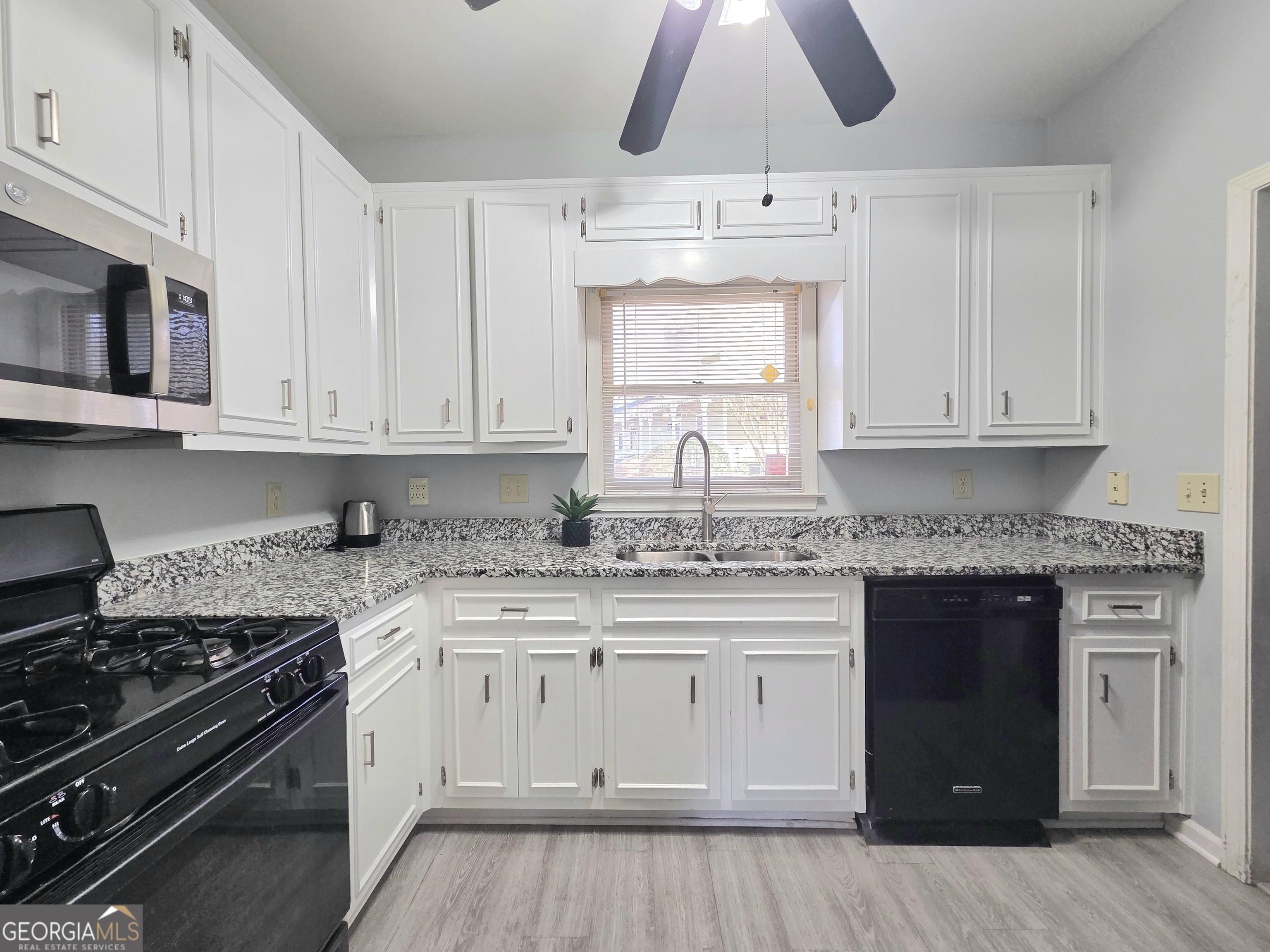 1426 Cambridge Common Decatur, GA 30033 - Photo 20 of 51 a kitchen with stainless steel appliances granite countertop a stove and a white cabinets