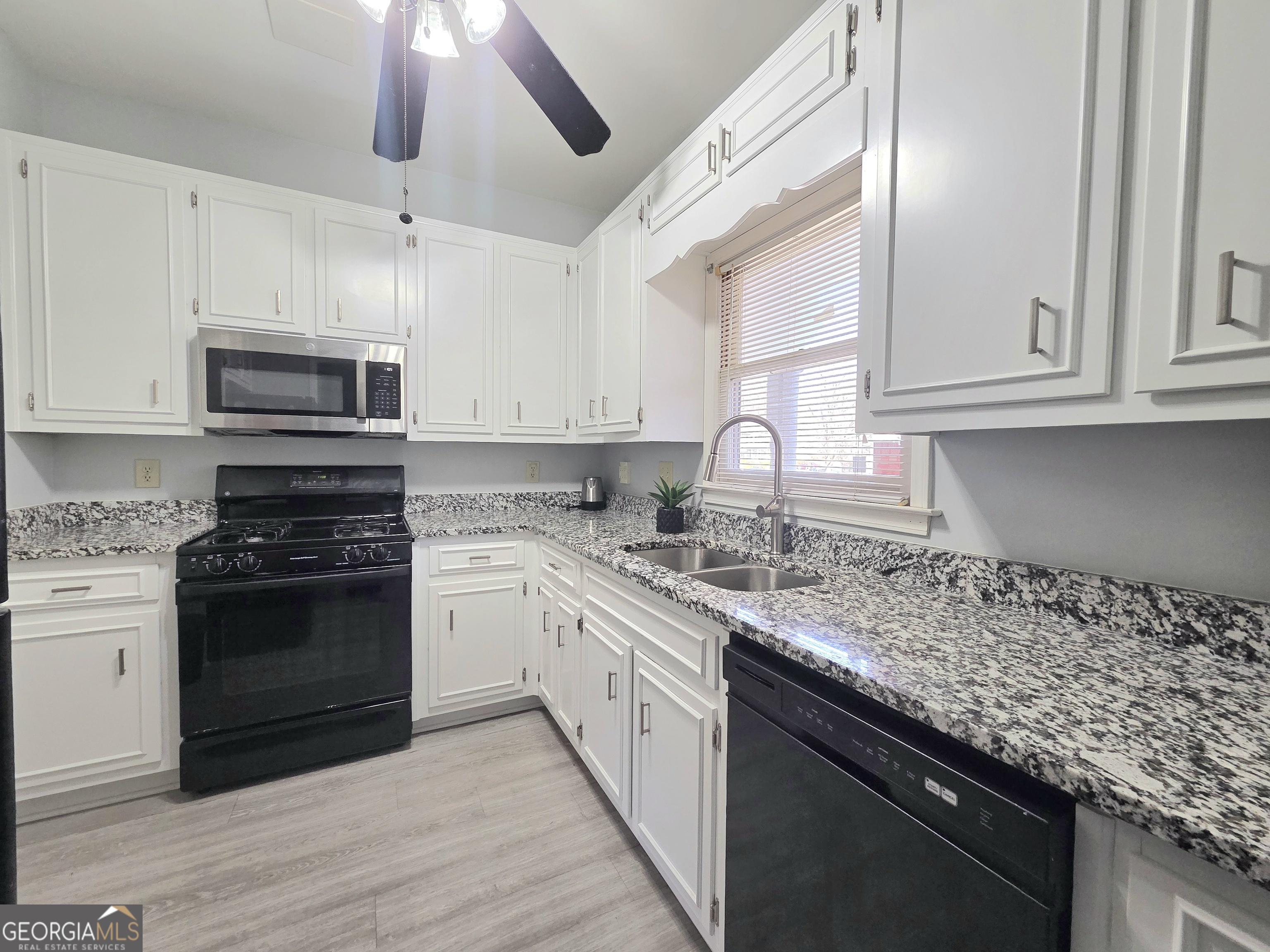 1426 Cambridge Common Decatur, GA 30033 - Photo 21 of 51 a kitchen with granite countertop a sink stainless steel appliances and cabinets