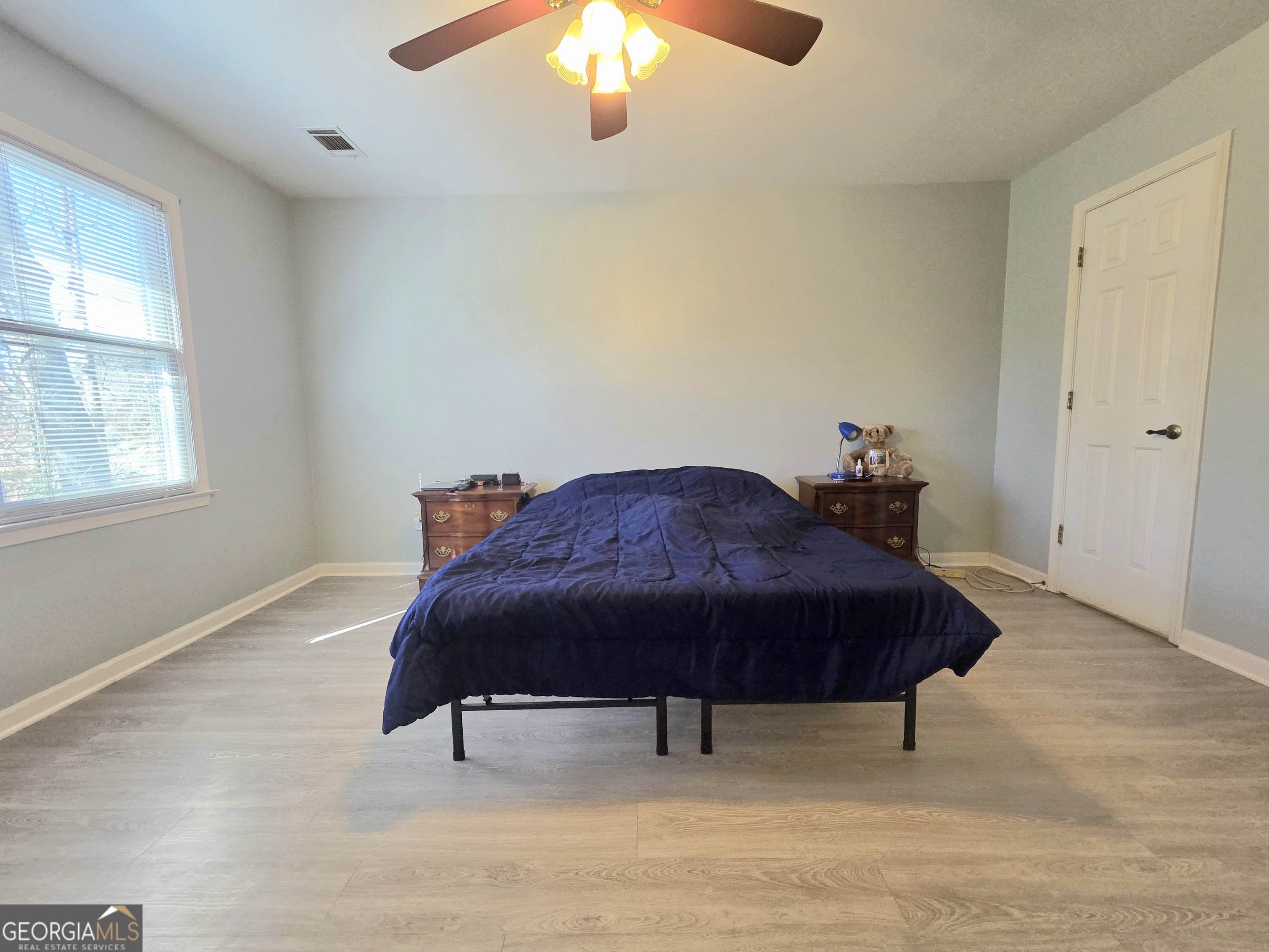 1426 Cambridge Common Decatur, GA 30033 - Photo 27 of 51 a bedroom with a bed and a chandelier