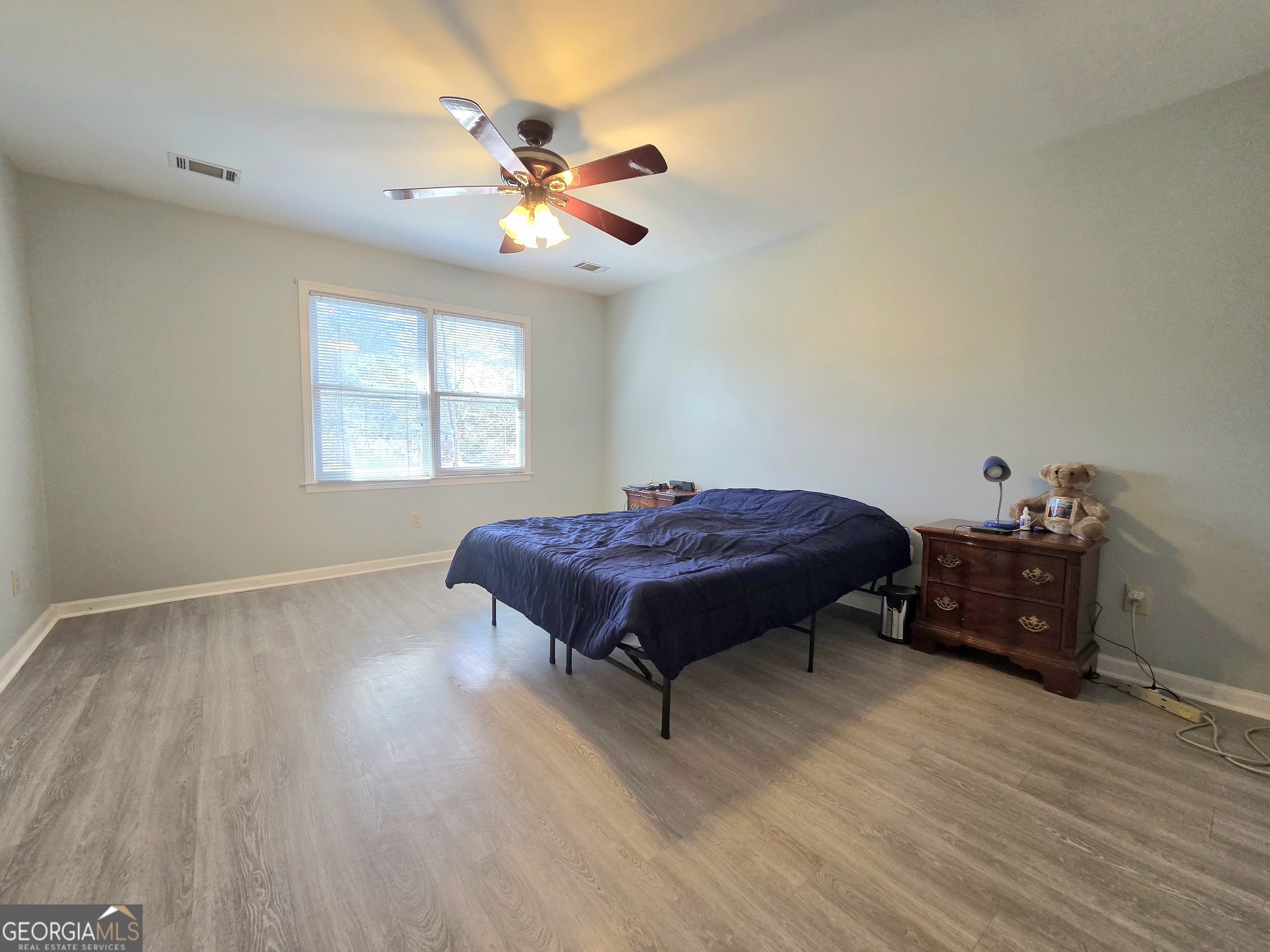 1426 Cambridge Common Decatur, GA 30033 - Photo 29 of 51 a bed sitting in a room next to a window and chandelier