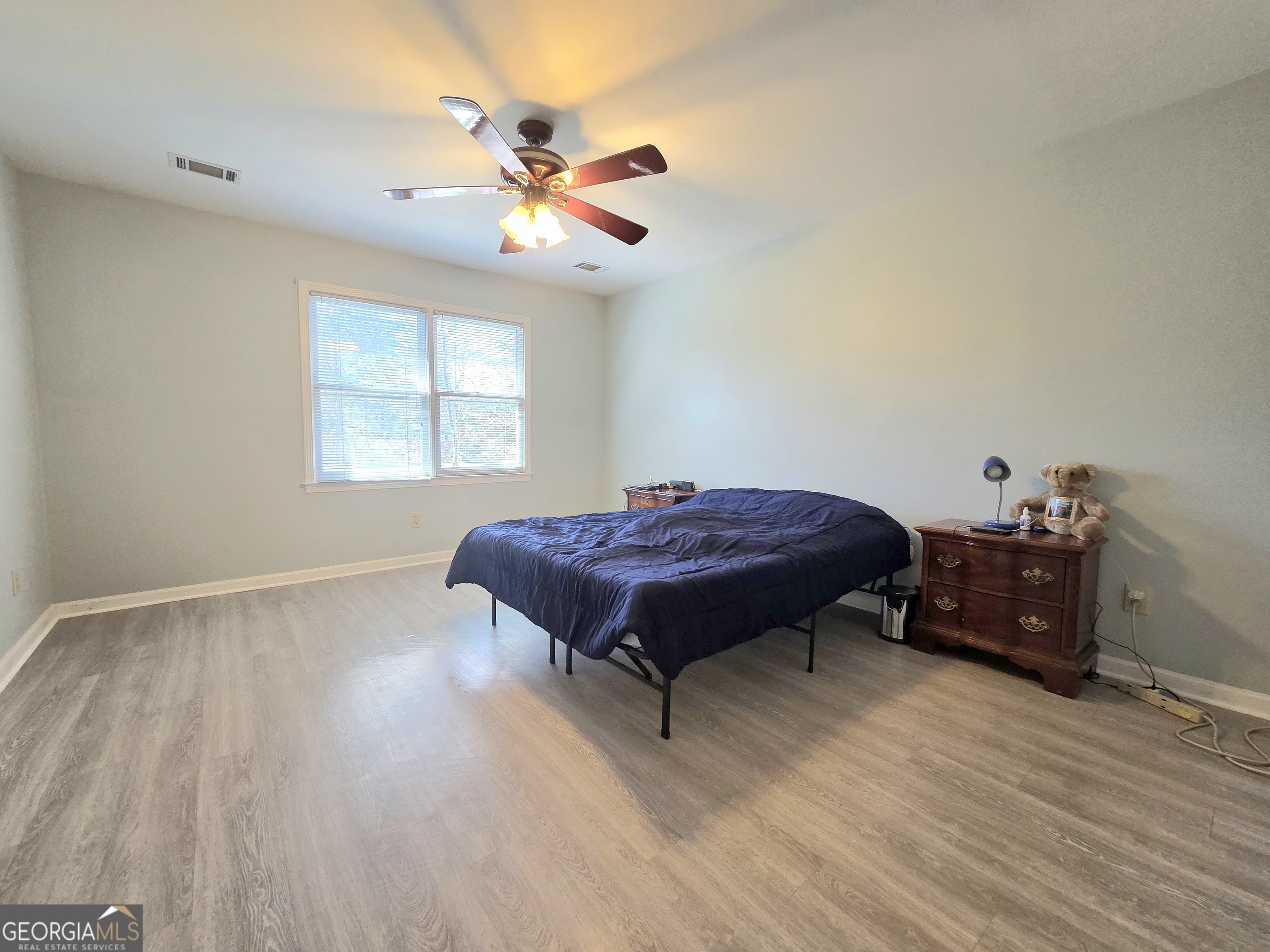 1426 Cambridge Common Decatur, GA 30033 - Photo 30 of 51 a bed sitting in a room next to a window and chandelier