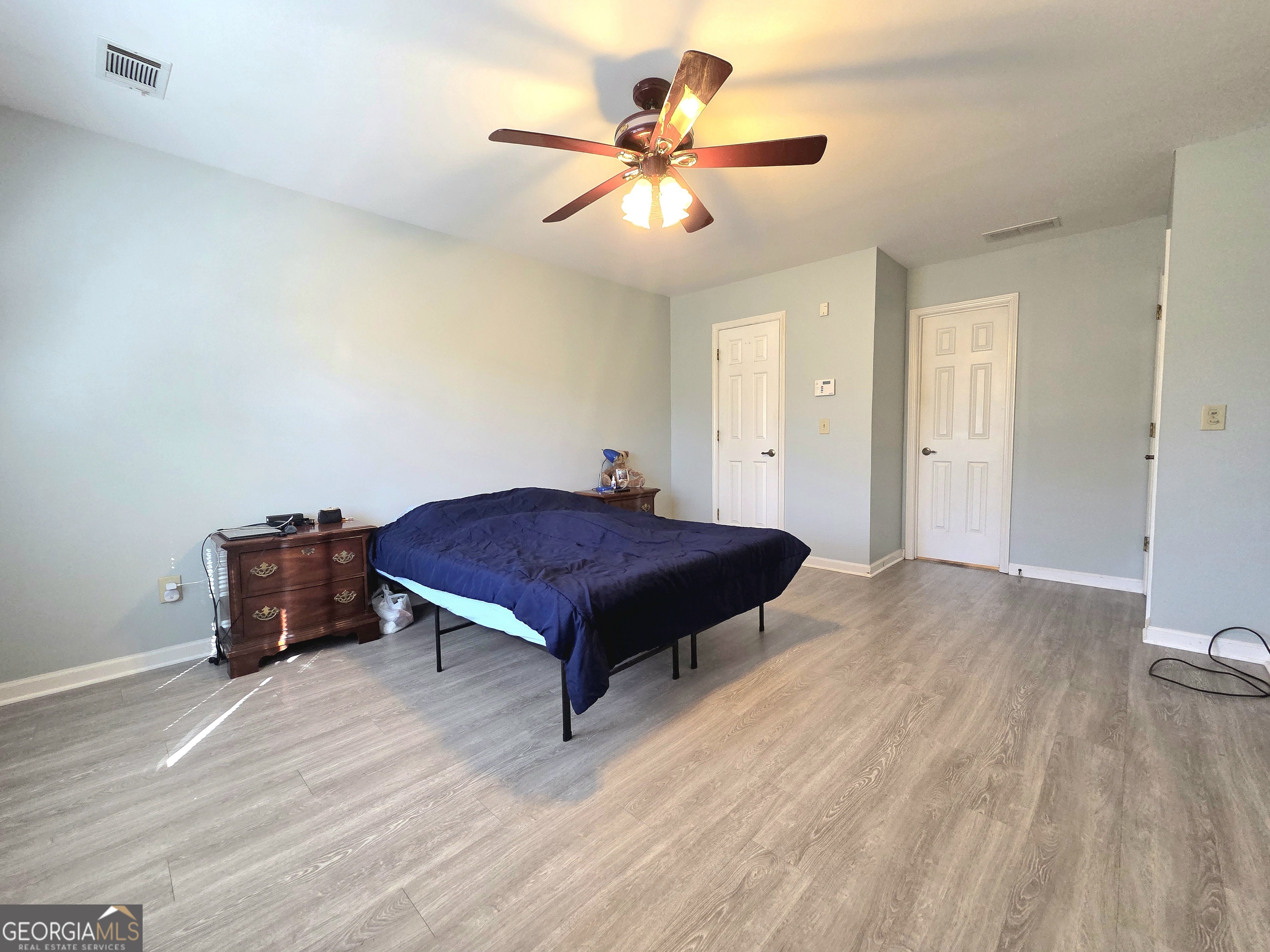 1426 Cambridge Common Decatur, GA 30033 - Photo 32 of 51 a living room with a bed and paintings on the wall