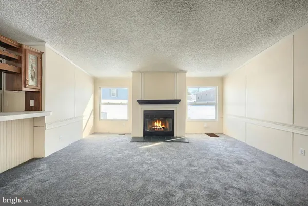 an empty room with closet and windows