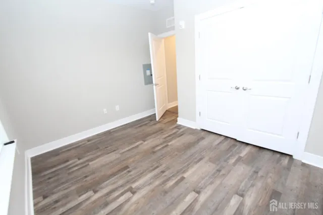 a spacious bathroom with a granite countertop sink toilet a mirror and a bathtub