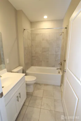 a bathroom with a double vanity sink toilet and shower