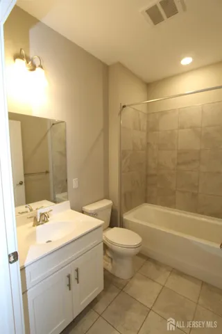 a bathroom with a sink a toilet and bathtub
