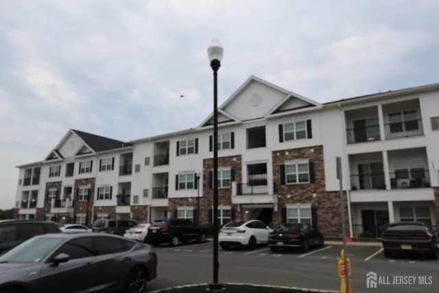 a city street lined with buildings and cars parked on the roadside