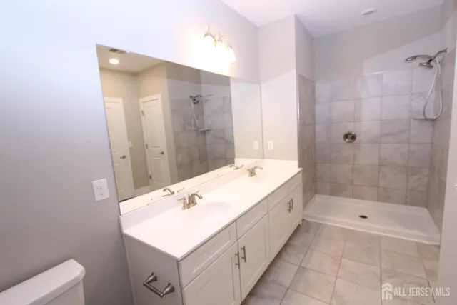 a bathroom with a sink a toilet and a mirror