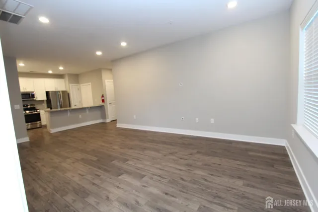 a view of a kitchen with a sink and a refrigerator