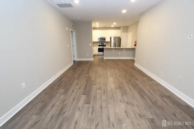 a view of a kitchen with wooden floor