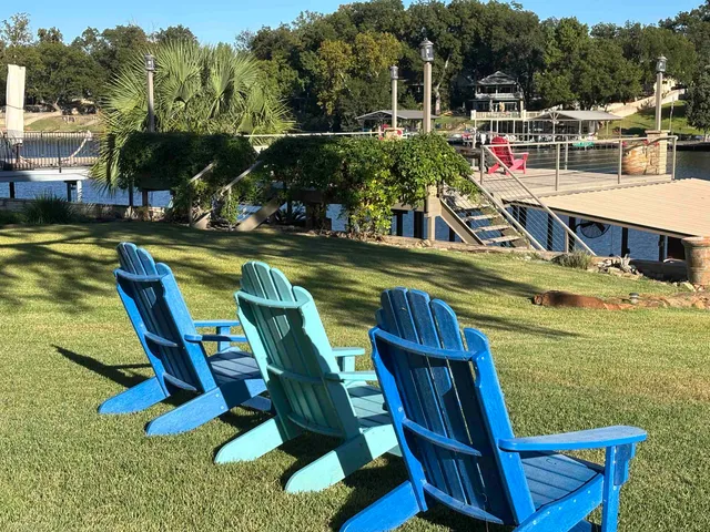 a spacious bathroom with a granite countertop sink a mirror and a shower