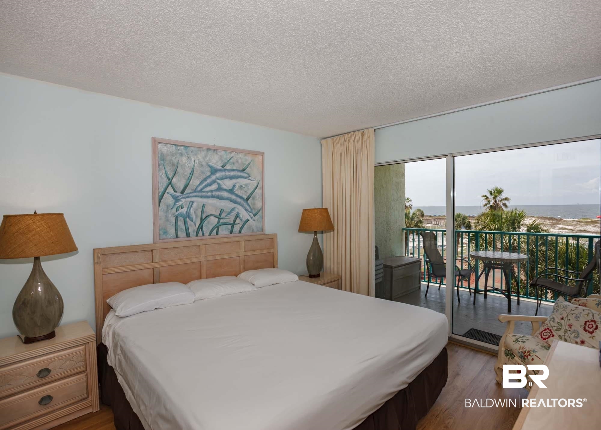 645 Plantation Road, Unit 6311 Gulf Shores, AL 36542 - Photo 29 of 43 Bedroom featuring access to exterior, wood finished floors, and a textured ceiling