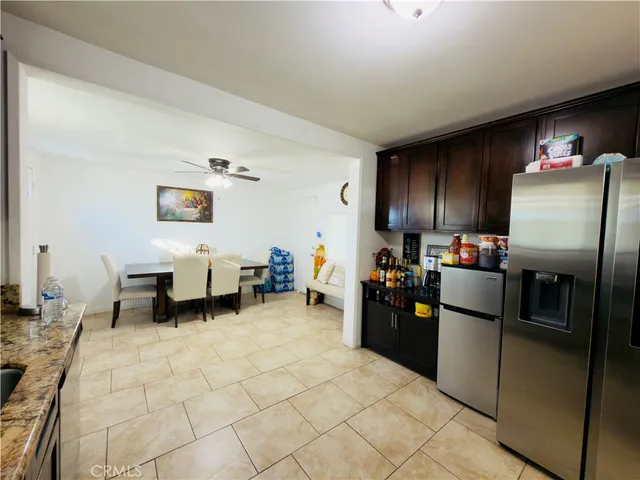 a kitchen with refrigerator and cabinets