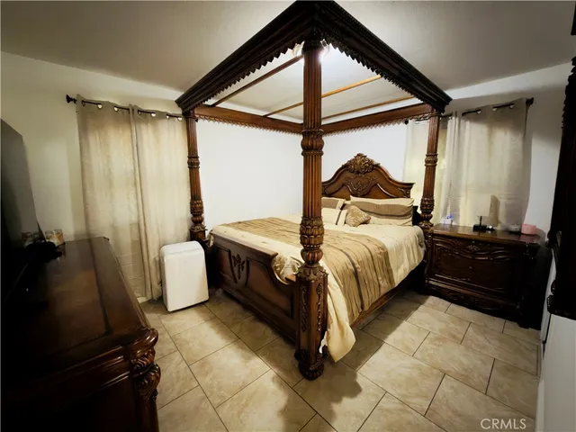 a bedroom with a bed and a mirror