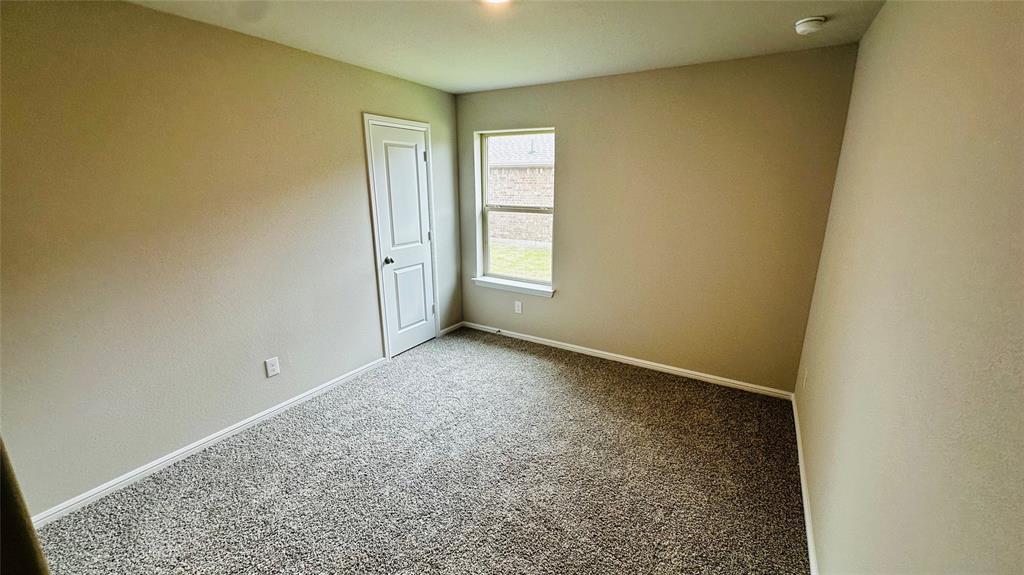 380 Wildrose Circle Cleburne, TX 76033 - Photo 14 of 20 an empty room with windows